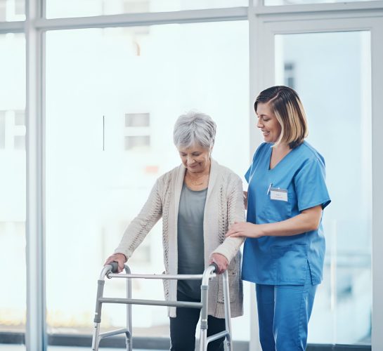 shot-young-nurse-helping-senior-woman-with-walker
